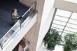 © Mint Images - High angle view of businesswoman using digital tablet in convention center