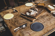 © Mint Images - Plates, cutlery and bread on wooden table