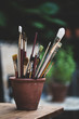 © Mint Images - Close up of paintbrushes in pot