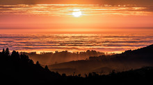 Brightly Colored Sunset In The Santa Cruz Mountains, Layered Hills And Valleys Visible In The Foreground And Sea Of Clouds In The Background; San Francisco Bay Area, California