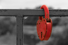 Close-up A Red Love Lock Hanging On A Metal Bridge Railing