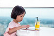 Leinwandbild Motiv Asian Little Chinese Girl playing with tablet