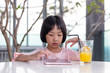 Leinwandbild Motiv Asian Little Chinese Girl playing with tablet