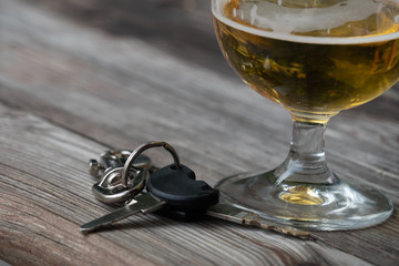 Drinking and driving - Vehicle keys near a glass beer