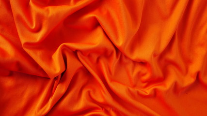 orange silk fabric background, texture of sportswear shirt