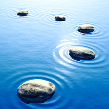 Pebble Stones In Water With Ripples Background