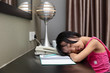 Leinwandbild Motiv Asian Little Chinese Girl falling asleep while doing homework
