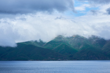 the endless water expanses of the lake Sevan on a cloudy day with clouds in the sky.