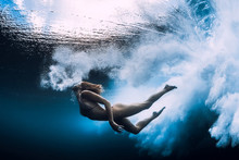 Woman Swim Underwater With Big Ocean Wave.