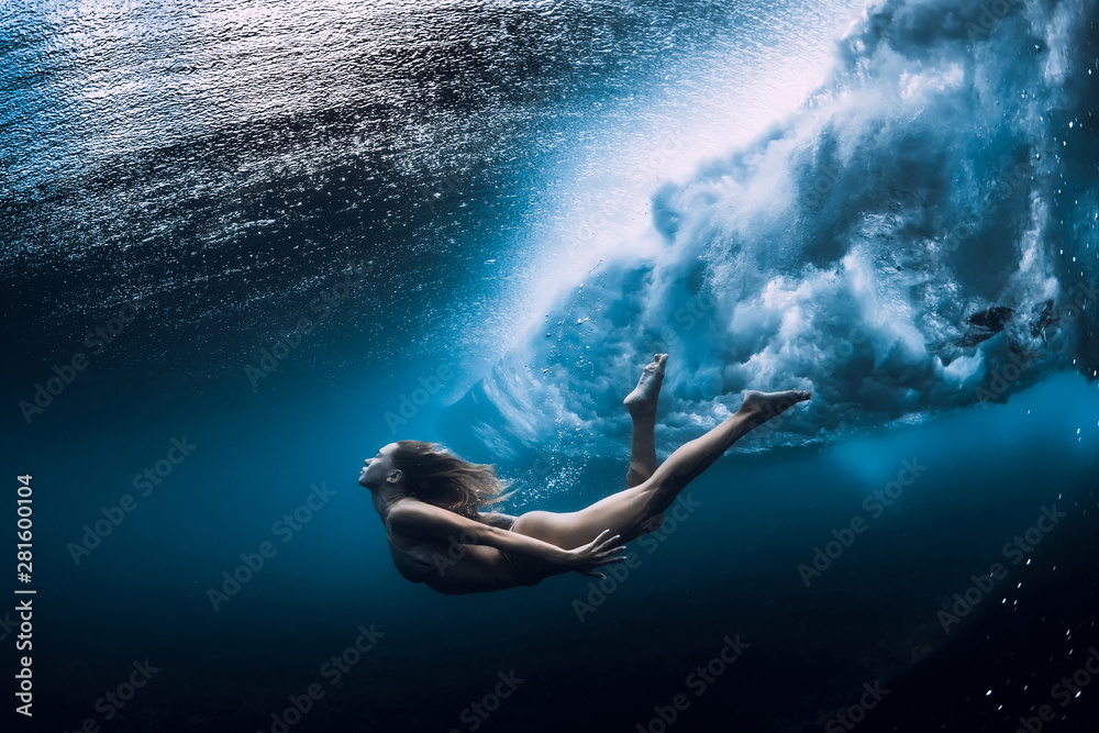 Woman swim underwater with ocean wave. - obrazy, fototapety, plakaty 