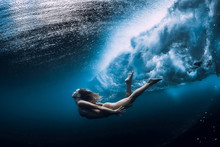 Woman Swim Underwater With Ocean Wave.