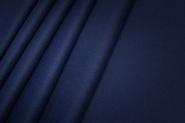 Wall Mural - The texture of the woolen fabric is dark blue. Background, pattern, knitwear.