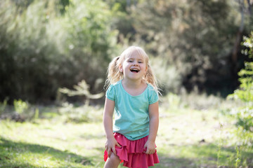 little girl in the park laughing