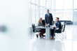 © opolja - Mature businessman talking and explaining his business strategy to his colleagues at office.