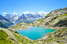 Beautiful Landscape Of French Alps. Turquoise Lake Blanc, In French Lac Blanc Photographed On A Sunny Summer Day With Mount Blanc And Other High Alpine Mountains In Background. Amazing Nature, France