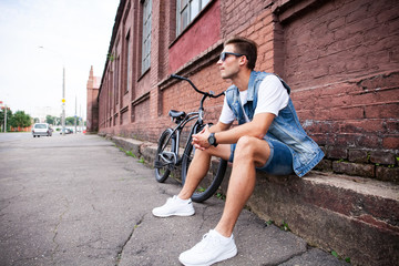 Wall Mural - portrait of a trendy young man in the city.