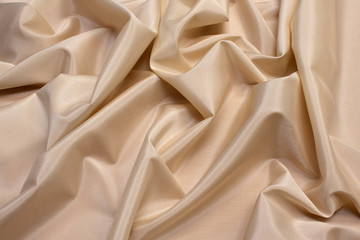 The texture of the synthetic fabric is light brown. Background, pattern.