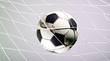 © suman - Scoring goal, Soccer ball in the net against gray background.