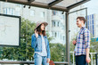 © Iryna - Love at first sight concept. Man and woman likes each other. Man and brunette girl stopped to get acquainted. Casual encounter, meet on sunny summer day at bus stop