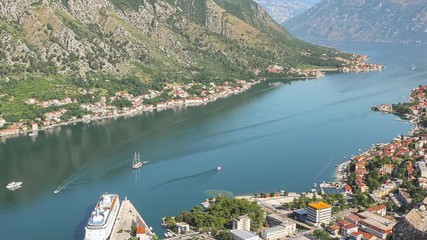 Wall Mural - View from above to the Kotor city and cruise ship in Boka Kotor bay, time lapse, panoramic motion