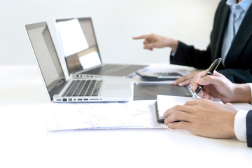 Poster - business man and woman sit at ther table looking at computer laptop