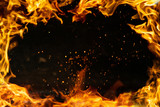 Fototapeta Kosmos - fire frame with sparks, isolated black inside