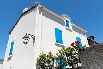 Wall Mural - White house with blue shutter in Trentemoult village in Brittany France