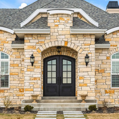 Wall Mural - Square Home facade with stone brick wall double glass paned door and arched windows