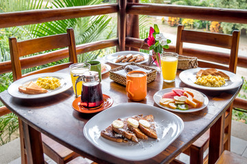 Full American Breakfast with coffee, orange juice, fresh fruits, eggs and french toasts for two