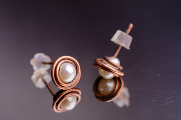 Creative handmade stud earrings. Jewelry background.