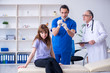 © Elnur - Two doctors examining young woman