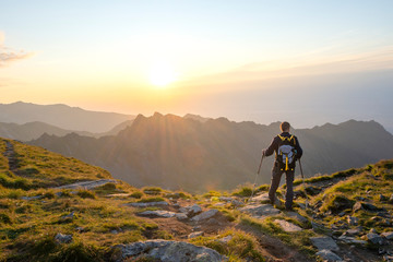 Successful active man hiker on top of mountain enjoying the view. Travel sport lifestyle concept