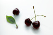 Black cherries on a white background, horizontal background