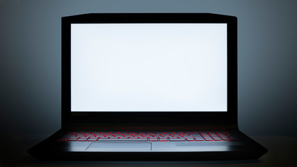 white blank computer screen in dark room
