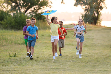 Sticker - Cute little children playing with kite outdoors