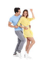 Poster - Beautiful young couple dancing on white background