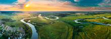 Aerial View Green Forest Woods Meadow And River Landscape In Sunny Spring Evening. Top View Of Beautiful European Nature From High Attitude In Summer Sunset Sunrise. Panorama, Bird's Eye View. Belarus