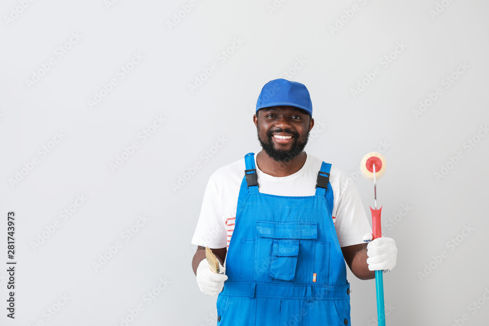 African-American painter on light background
