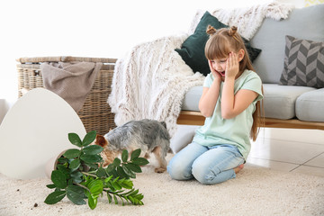 Wall Mural - Cute little girl with dog and dropped houseplant on carpet