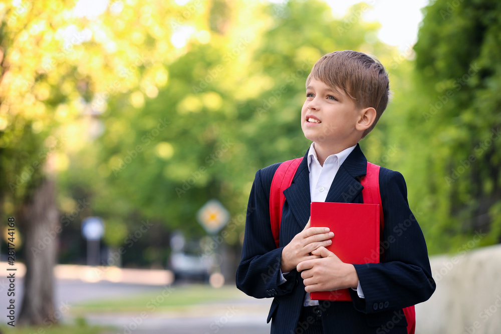 Cute little pupil after classes outdoors