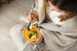 © Pixel-Shot - Woman eating tasty cream soup at home
