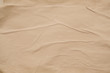 Brown colored wet paper. Wrinkled texture layers. Abstract art background. Copy space.