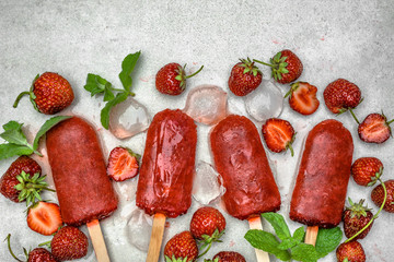 Wall Mural - Red popsicles with fruits. Strawberry popsicle, iced dessert, top view.