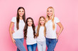 © deagreez - Photo of four different age ladies hugging wear casual outfit isolated pink background