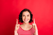 Close-up portrait of her she nice-looking attractive lovely cheerful cheery glad content wavy-haired lady pointing two forefingers up cool ad advert isolated over bright vivid shine red background