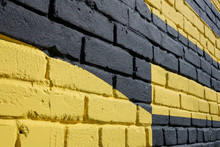 Brick Wall Painted In Yellow And Black