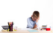 © tavrox - Cute little school boy with sad face sitting at his desk on white background.Unhappy intelligent children in shirt with blue eyes crying