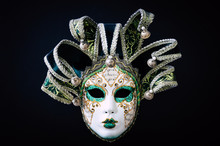 Venetian Carnival Mask Isolated On Black Background. Traditional Carnival In Venice. Green And White Mask With Glitters. Masquerade Party. Mardi Gras, Costumes. Concept, Abstract