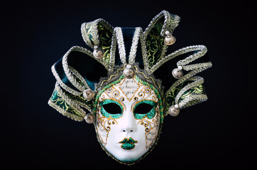 Venetian carnival mask isolated on black background. Traditional carnival in Venice. Green and white mask with glitters. Masquerade party. Mardi Gras, costumes. Concept, abstract