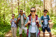 © Syda Productions - travel, tourism, hike and people concept - group of friends with backpacks in forest